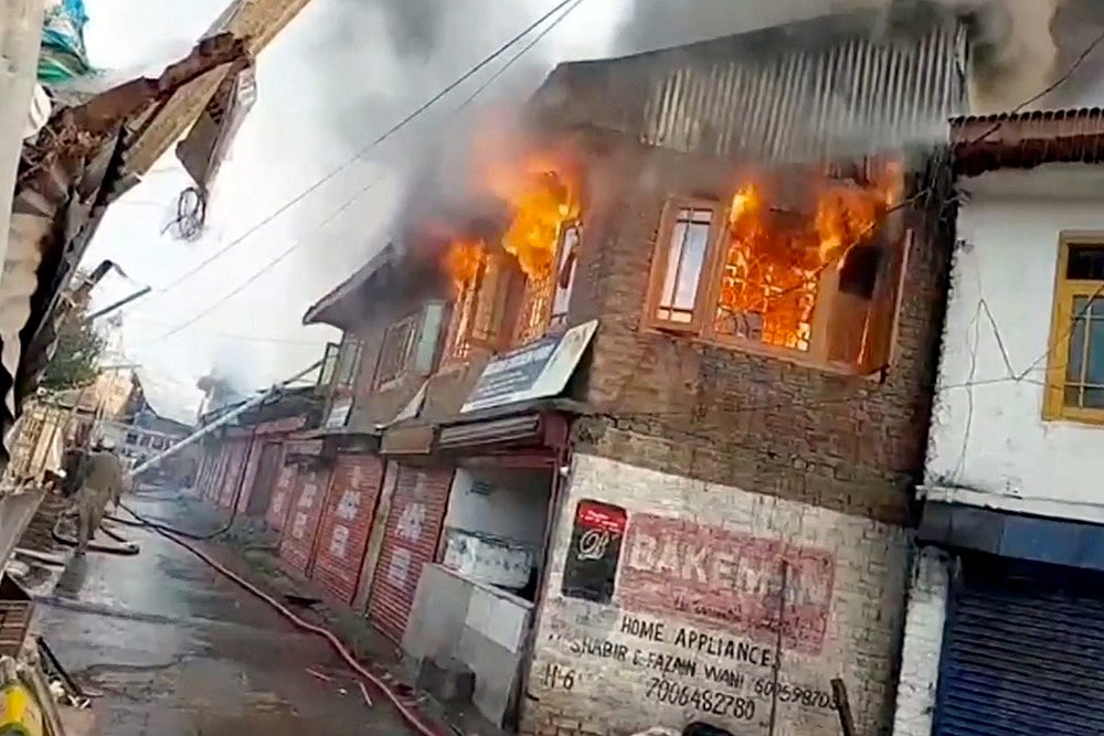 | Photo: PTI : Fire at shops in J&K's Kupwara